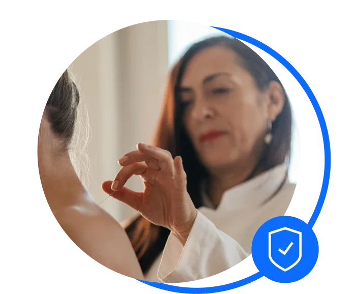 Acupuncturist working on client